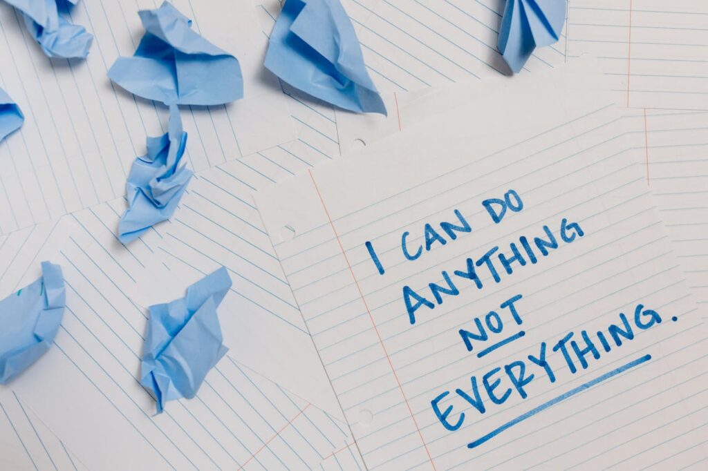 Inspirational quote on paper surrounded by crumpled blue sheets conveying motivation